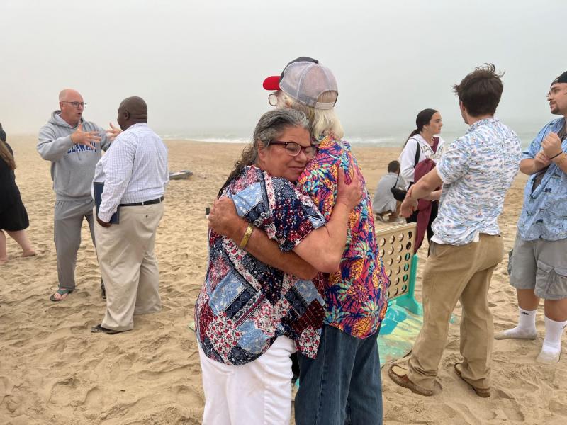 Maria Payan, SHEN co-founder, embraces Kenny Haynes, husband of the late Joanne Haynes, during the awards ceremony.